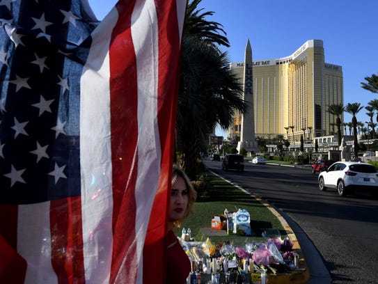 The US flag is left at a makeshift memorial outside