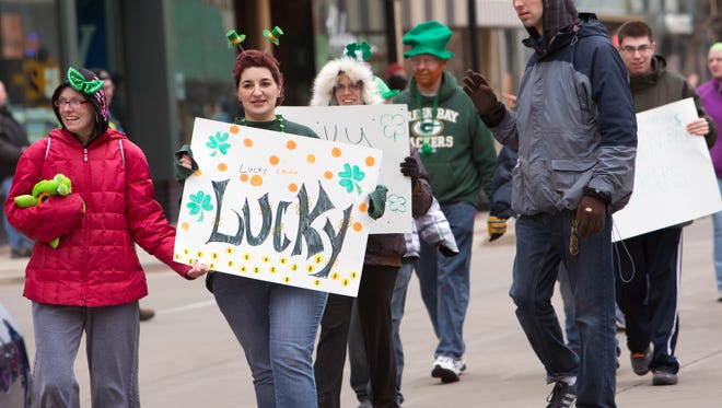 Clarity Care supporters walk in the Oshkosh St. Patrick's Day parade on Saturday, March 19, 2016.
