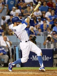 The Dodgers' Chris Taylor hits an RBI single against