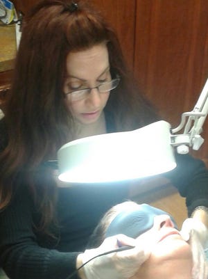 Cathy DeMattia of Bonita Springs receives electrolysis treatments from Theresa George, an electrologist at Theresa’s Face and Body in Cape Coral.