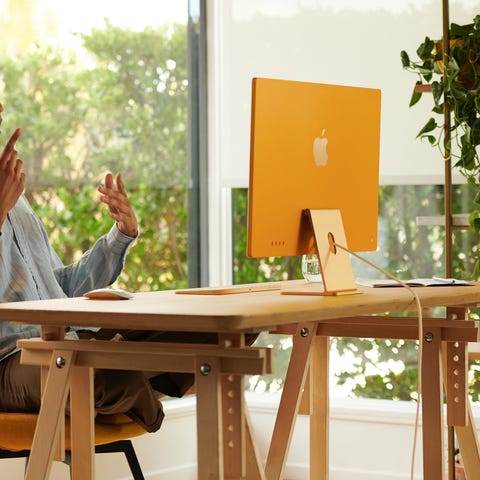 Person using a gold iMac computer.