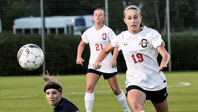 Oakland’s Katie Webb goes for the ball as Blackman’s Carly Bowen watches from ground level. Oakland won 4-1 over Blackman in a District 7-AAA semifinal.