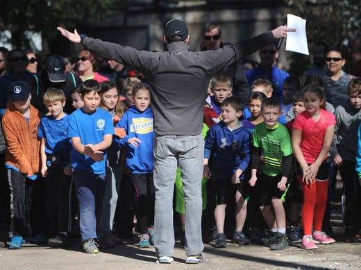Jason Altman, race director for the Covenant Health Knoxville Marathon, center, gathers kids at the starting line for the Covenant Kids Run, a 1-mile fun run at the Knoxville Zoo on Saturday, Jan. 30, 2016. Hundreds of boys and girls from across East Tennessee completed their first mile as part of the 26.2-mile challenge in a staggered version of a marathon. 