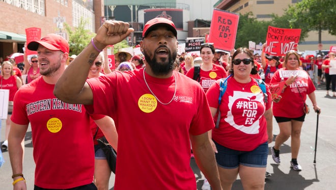 Karl Evans, a physical education teacher at Imagine Schools in Tempe marches from Chase Field in downtown Phoenix to the Arizona capitol on the first day of the Arizona teacher walkout on April 26, 2018.