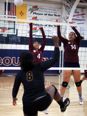 Myka Trevizo (4) and Liz Perez (14) team on the Lady Cat block during Saturday's volleyball match against Alamogordo. The Tigers beat the Lady Cats in five games. Deming girls will open District 3-6A play today at 6 p.m., against the visiting Gadsden High Panthers at Deming High School.