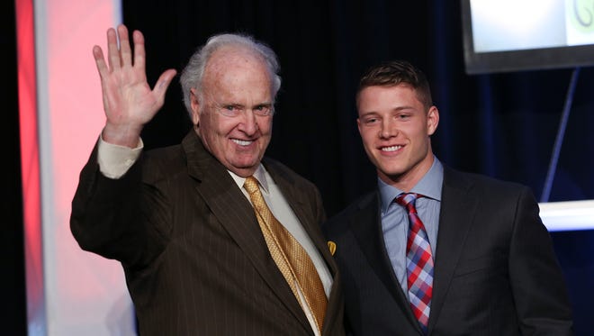Football legend Paul Hornung, left, waved to the crowd with Paul Hornung Award recipient Christian McCaffrey of Stanford University during the awards banquet at the Galt House.Feb. 25, 2016