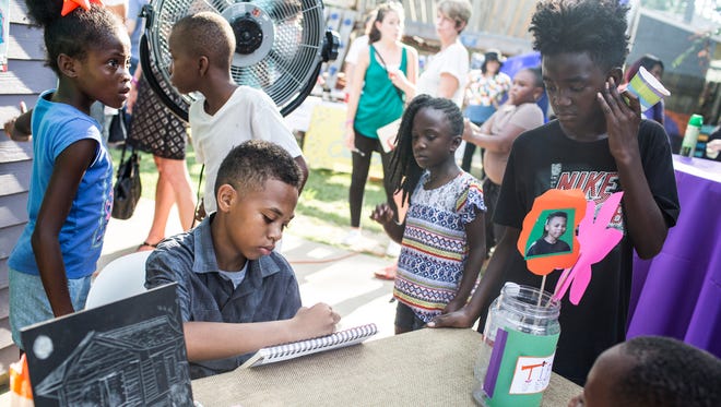 July 21, 2017 - Tariq Muhammad, center, focuses on drawing a freehand portrait during the 5th anniversary celebration for the Carpenter Art Garden. The Carpenter Art Garden works with the children of Binghampton in artistic, educational and vocational programs.