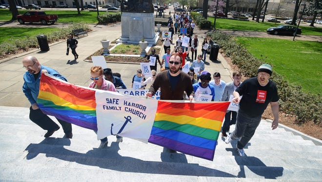 In this file photo, members of Flowood's Safe Harbor Family Church lead a procession during a rally against discrimination toward members of the state's gay, lesbian, bisexual and transgender  community
