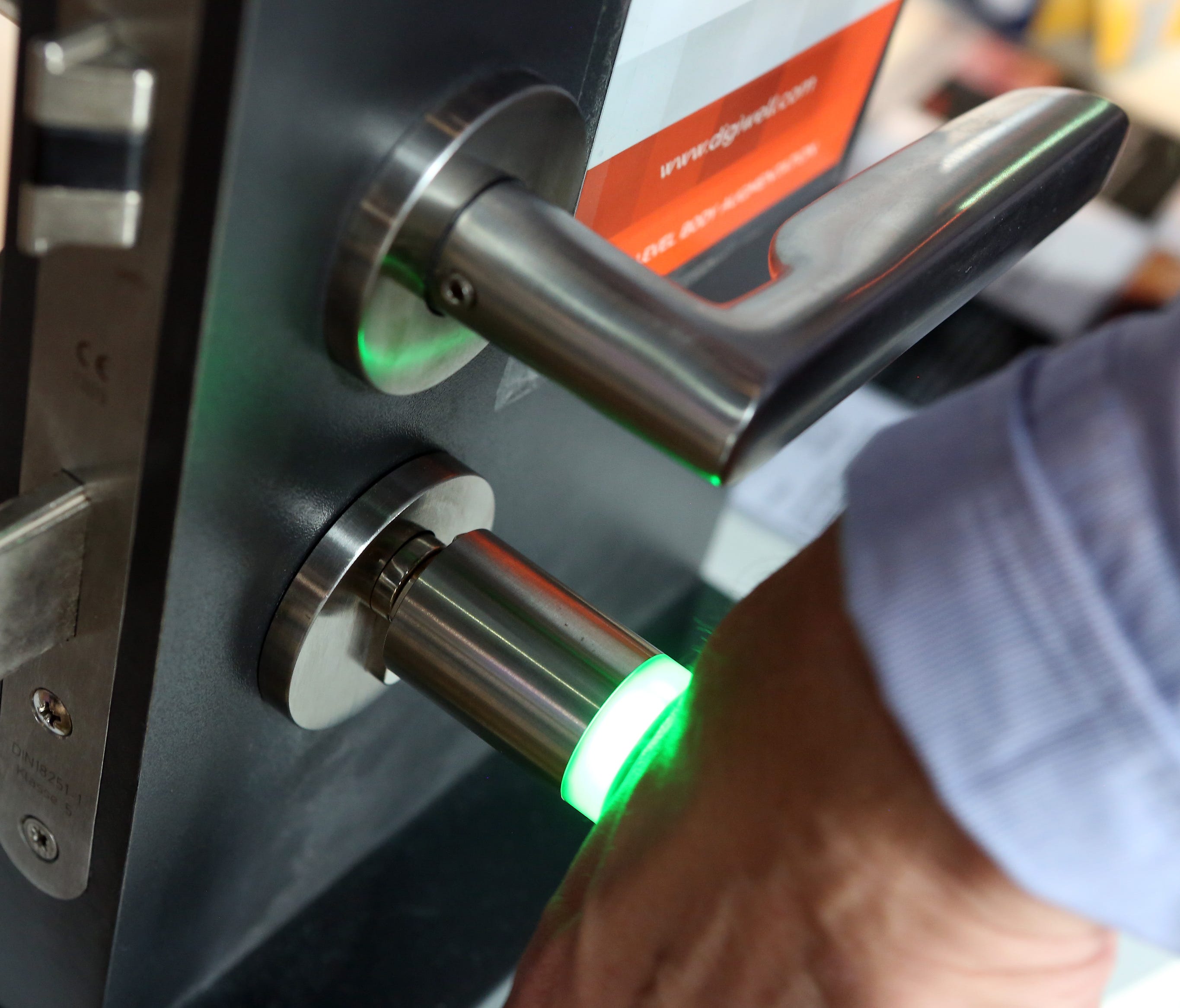 Patrick Kramer of the company Digiwell uses the microchip implanted in his hand to open a door lock at a press preview of the Wear-it festival in Berlin on June 8, 2017.  The Wear It Festival takes place on June 8 and 9, 2017 in Berlin and shows the p