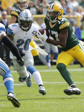 Green Bay Packers wide receiver Davante Adams (17) makes a touchdown reception despite the efforts of Detroit Lions free safety Glover Quin (27) during the first quarter of their game Sunday, September 24, 2016 at Lambeau Field.