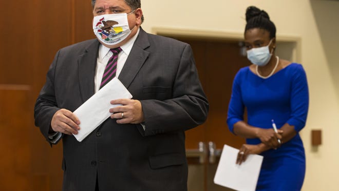 Illinois Governor JB Pritzker walks out with IDPH Director Dr. Ngozi Ezike for a press conference to speak about the state surpassing 5 million COVID-19 tests since the beginning of the pandemic at the Memorial Center for Learning and Innovation, Monday, September 21, 2020, in Springfield, Ill.
