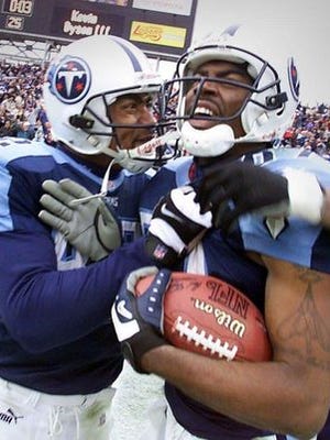 Yancey Thigpen, left, congratulates Titans wide receiver Kevin Dyson, who scored on the “Music City Miracle” with seconds to play in a 2000 playoff game against Buffalo.