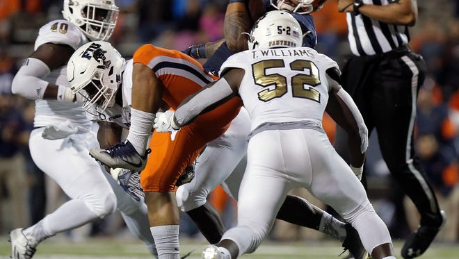 UTEP running back Darrin Laufasa is sandwiched between a pair of FIU defenders Saturday. 