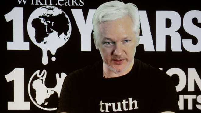 In this Oct. 4, 2016 file photo, WikiLeaks founder Julian Assange participates via video link at a news conference marking the 10th anniversary of the secrecy-spilling group in Berlin. Assange may be stuck in the Ecuadorean Embassy and cut off from the internet, but he's closer than ever to testing a hypothesis he first outlined nearly a decade ago. Can total transparency defeat an entrenched group of insiders?