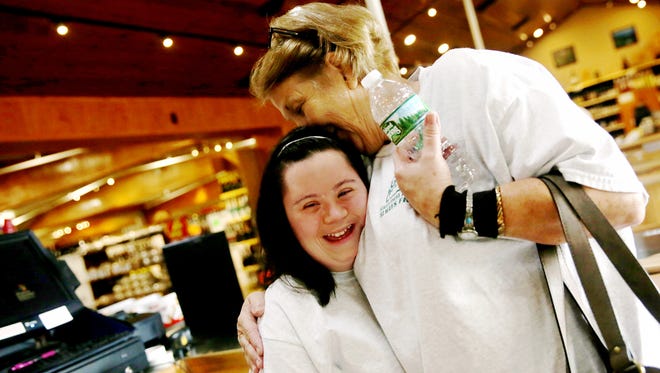 Cashier Sherry Phillips, right, hugs Caitlin Roggia, both of Naples, at Oakes Farms Market with Trailblazer Academy through the Foundation for the Developmentally Disabled in Naples on Thursday, Oct. 6, 2016. The Trailblazer Academy is a program designed to give adults with intellectual and developmental disabilities vocational training to help gain independence. 
