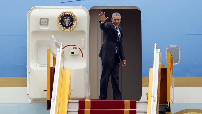 President Obama waves as he boards Air Force One before his departure at Noi Bai International Airport in Hanoi, Vietnam, on May 24.