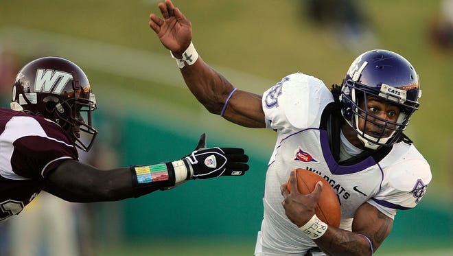 Abilene Christian University running back Bernard Scott (3) slips away from a West Texas A&M defender during the first quarter of their 2008 game at Kimbrough Memorial Stadium in Canyon.