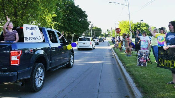 On Wednesday evening, students and families participated in a "Last Day of School" parade in Nevada to celebrate the end of the school year at the Nevada community school district. During the parade, students had the opportunity to show off signs and wave goodbye to Nevada teachers and staff who lined up on sidewalks along the route. Photo by Nirmalendu Majumdar/Ames Tribune