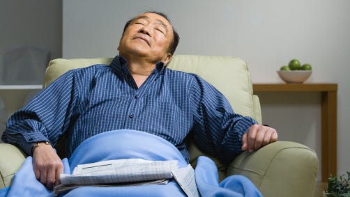 Senior man sleeping in chair