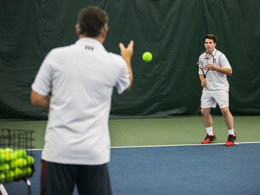 Edward Apple, 19, works on his forehand exercises with