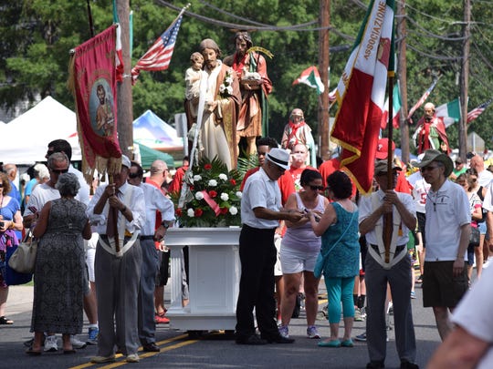 Visitors crowded Third Street to make offerings to the saints as the 141st Feast Day procession of the saints began on Saturday, July 16.