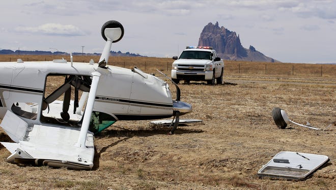 A small passenger plane sits off the runway after being flipped by the wind on Thursday at the Shiprock Airstrip.