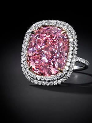 In this undated photo provided by Christie’s Auction House in New York, a 16.08 carat, a pink diamond the size of a postage stamp is shown in a ring setting. It could set a record for a cushion-shaped fancy vivid pink diamond when it’s offered Christie’s at its Magnificent Jewels sale in Geneva on Nov. 10, where it is estimated to bring as much as $28 million.