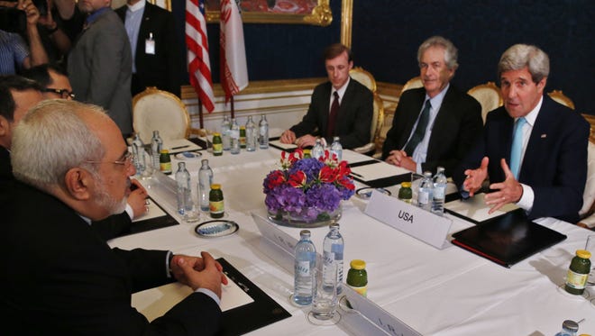 Iran's Foreign Minister Mohammad Javad Zarif, left, meets with U.S. Secretary of State John Kerry, right, at talks between the foreign ministers of the six powers negotiating with Tehran on its nuclear program in Vienna, Sunday, July 13, 2014.  Discussions center on imposing long-term restrictions on Iran's uranium enrichment and against plutonium production ? materials usable in nuclear warheads. In exchange, the U.S. and other powers would scrap a series of trade and oil sanctions against Tehran.  (AP Photo/Jim Bourg, Pool)