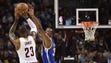 LeBron James shoots as Kevin Durant guards during the