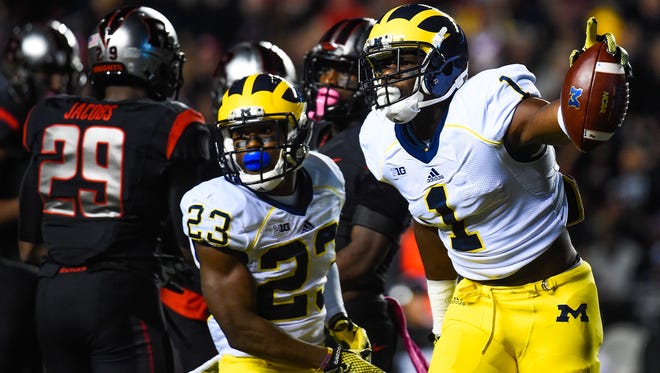 Devin Funchess #1 and Dennis Norfleet #23 of the Michigan Wolverines celebrate a play in the first quarter against the Rutgers Scarlet Knights at High Point Solutions Stadium on October 4, 2014 in Piscataway, New Jersey.