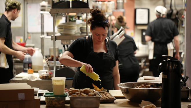 Chef Kate Williams plates a dish in the kitchen of her Lady of the House restaurant in Corktown.