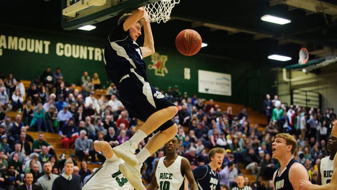 MMU's Tyler Muttilainen (11) dunks the ball during the Vermont state division I boys basketball semifinal game between the Mount Mansfield Cougars and the Rice Green Knights at Patrick Gym on Thursday night March 15, 2018 in Burlington.