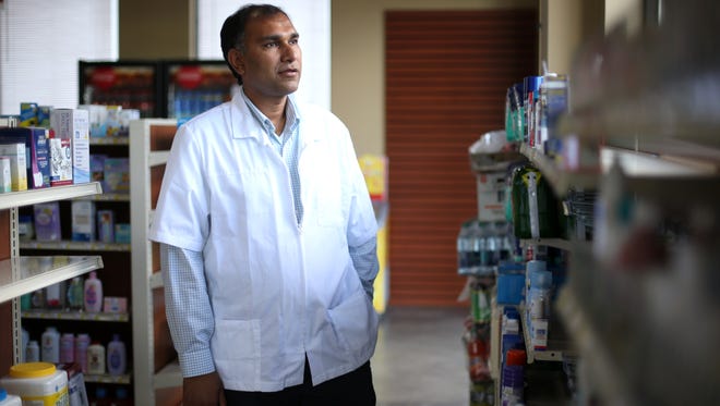Harsh Patel stands in the aisle of his store, Care Rx Pharmacy, where after working as a pharmacist with big box and chain stores for years, he has decided to open his own independent store. 