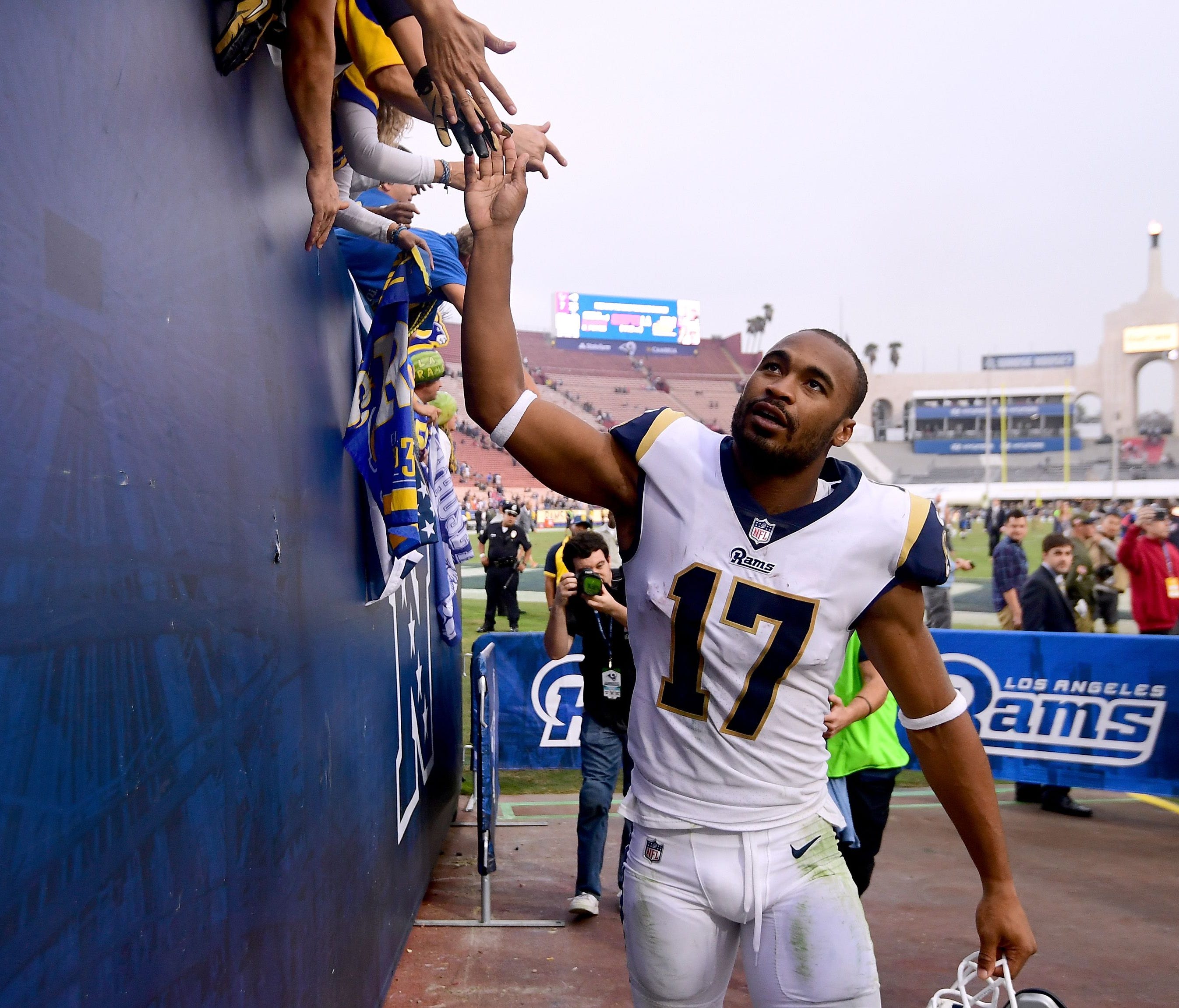 Los Angeles Rams receiver Robert Woods celebrates with fans during a recent victory.