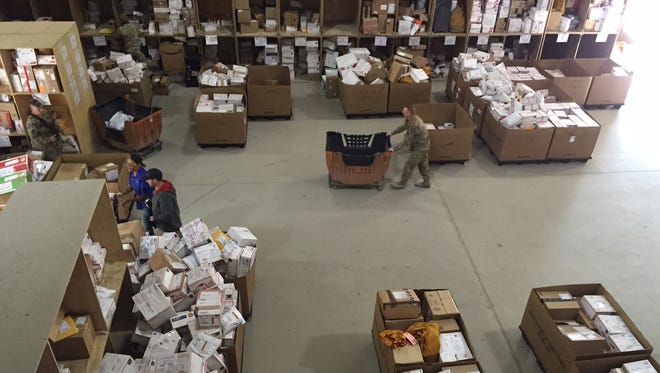 Holiday packages make their way through the Bagram Air Base postal facility in Afghanistan. A military contractor was convicted of shipping home to Texas laptops and hard drives full of classified records before his arrest in 2017.