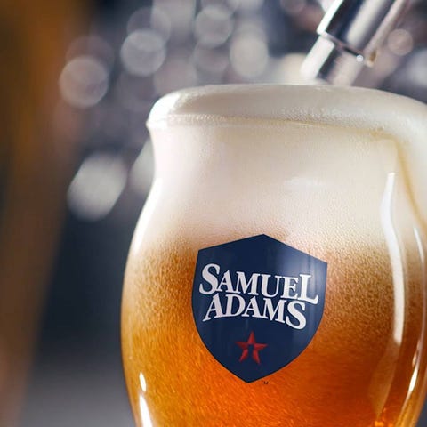 Samuel Adams glass being filled from tap with foam