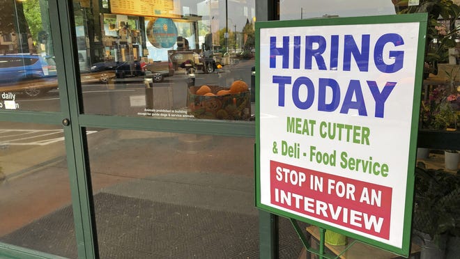 A sign that reads "hiring today," is shown at a grocery store in Olympia, Wash., advertising a job opportunity for a meat cutter on Oct. 3, 2020.   On Thursday, Oct. 22, the number of Americans seeking unemployment benefits fell last week to 787,000, a sign that job losses may have eased slightly but are still running at historically high levels.