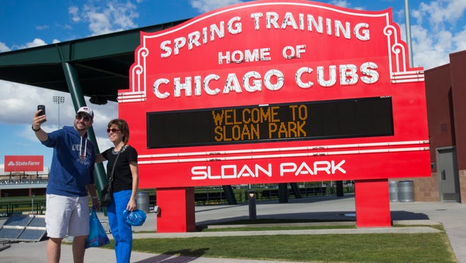 Donnie Tanski takes a selfie with his mom, Patti, in front of a newly unveiled marquee for Sloan Park, the spring-training home for the Chicago Cubs. Illinois-based Sloan Valve bought naming rights to the second-year Mesa facility before this Cactus League season.
 Michael Chow/The Republic
Donnie Tanski takes a picture with his mom, Patti, in front of a newly unveiled marquee for Sloan Park, the spring training home for the Cubs in Mesa February 24, 2015.
