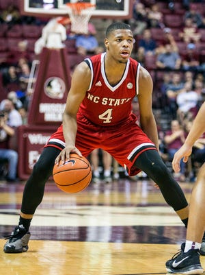 North Carolina State guard Dennis Smith dribbles the ball against Florida State.