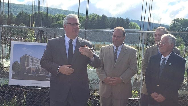 State Sen. Tom O'Mara,  left, talks about construction resuming on the Hilton Garden Inn hotel project in Corning during an August news conference.