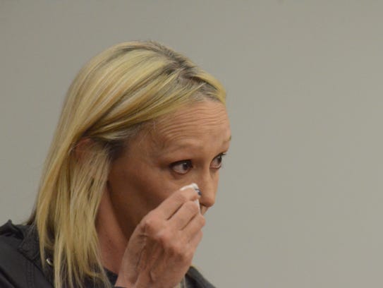 Foster parent Michelle Woodard wipes away tears as