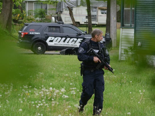 Lt. Matthew Robinson patrols near a house on Somerset