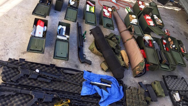 FILE - This undated file photo released Wednesday, Aug. 21, 2019 by the Long Beach, Calif., Police Department shows weapons and ammunition seized from a cook at a Los Angeles-area hotel who allegedly threatened a mass shooting. Thereâs been a big increase in the number of tips to U.S. law enforcement about potential mass shootings following the three shootings in August that killed 34 people. Experts say media coverage of the shootings makes the public more prone to inform on worrisome relatives or neighbors in attempts to prevent more shootings. Following the high-profile shootings in California and Texas and Ohio, tips to the FBI rose by about 15,000 each week. (Long Beach Police Department via AP, File)