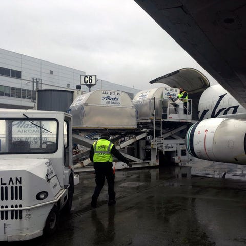 Alaska Airlines employees load cargo Sept. 27, 201