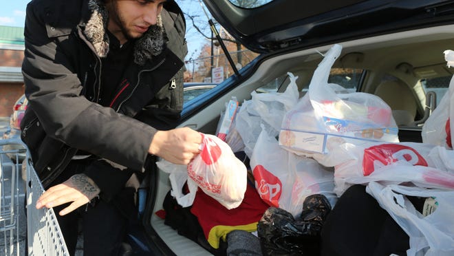 A shopper loads groceries into his car at the Hastings-on-Hudson A&P in November 2014. The City of Yonkers is among municipalities considering bans or restrictions on plastic supermarket bags.