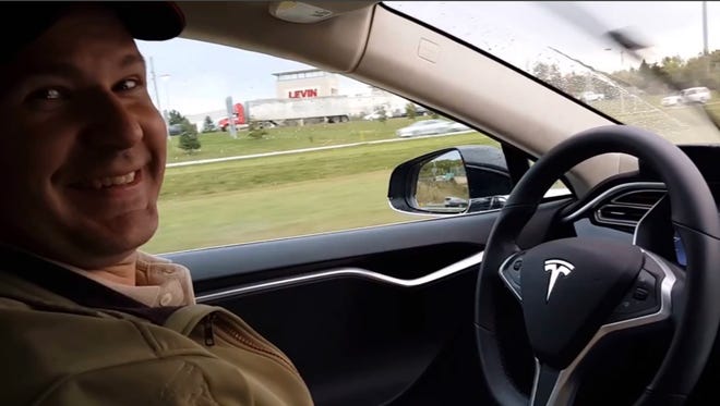 This still image taken from a video published on YouTube on Oct. 15, 2015, shows Joshua Brown of Canton, Ohio, in the driver's seat of his Tesla Model S with no hands on the steering wheel while he demonstrates the car's self-driving mode. Brown was killed on May 7, 2016, in Williston, Fla., when his car hit a tractor-trailer while it was on the Autopilot system.