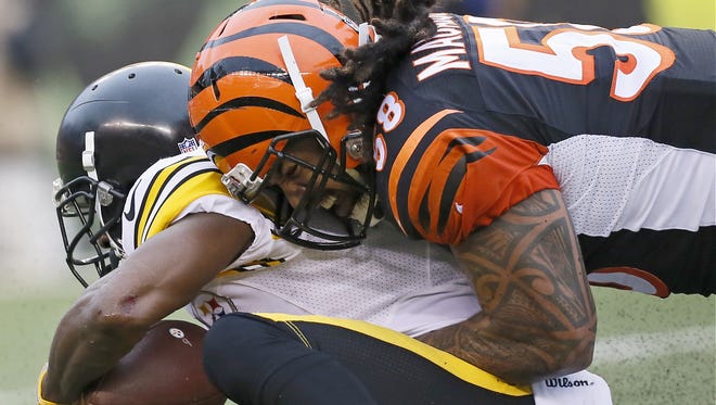 Cincinnati Bengals middle linebacker Rey Maualuga (58) makes a tackle in the third quarter of the NFL Week 14 game between the Cincinnati Bengals and the Pittsburgh Steelers at Paul Brown Stadium in downtown Cincinnati on Sunday, Dec. 13, 2015. The Bengals fell to 10-3 with a 33-20 loss to the Steelers.