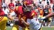 USC quarterback Sam Darnold scrambles from a tackler