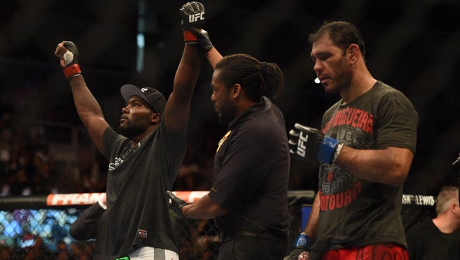 Anthony Johnson, left, celebrates his victory against Antonio  Nogueira following the light heavyweight bout Saturday