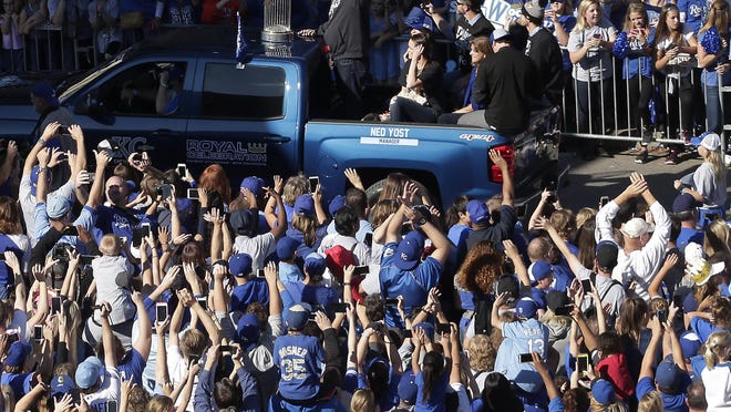 Kansas City Royals manager Ned Yost waves to the crowd during a parade celebrating the Royals winning baseball's World Series Tuesday, Nov. 3, 2015, in Kansas City, Mo. The Royals beat the New York Mets in five games to win the championship. (AP Photo/Charlie Riedel)